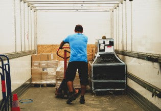 Man loads a trailer with cargo