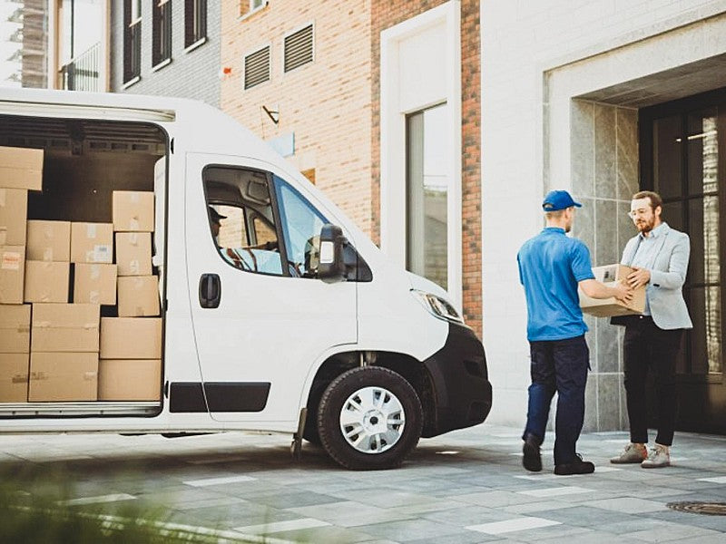 Man receives package from delivery driver